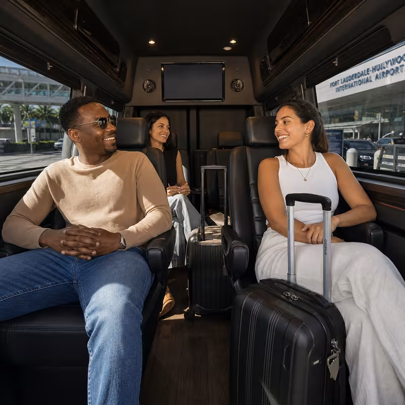 Passengers loading luggage while boarding an Fort Lauderdale group shuttle