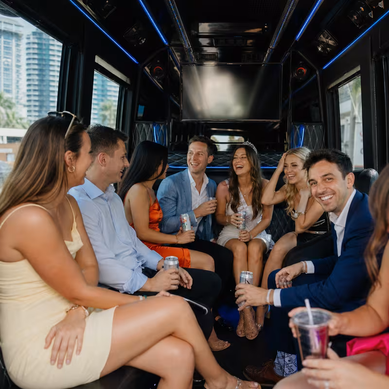 Party bus interior with wraparound leather seating and LED lighting in Fort Lauderdale