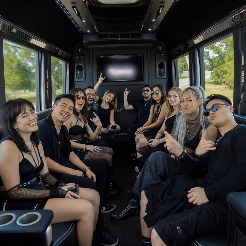 Group boarding a white charter bus for Concert Transportation transportation in Fort Lauderdale
