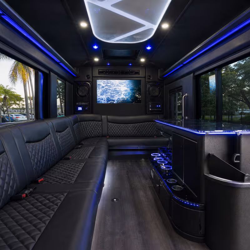 Party bus interior with wraparound leather seating and LED lighting in Fort Lauderdale