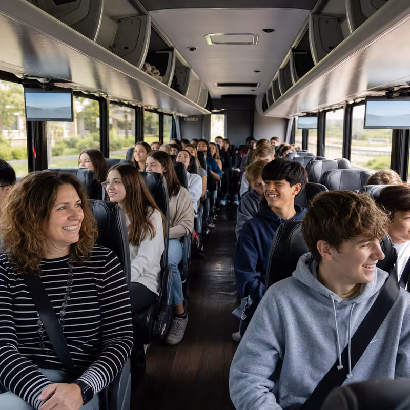 Group boarding a white charter bus for School Transportation transportation in Fort Lauderdale