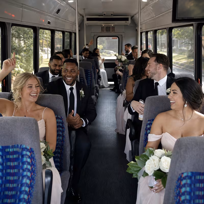 Group boarding a white charter bus for Wedding Transportation transportation in Fort Lauderdale