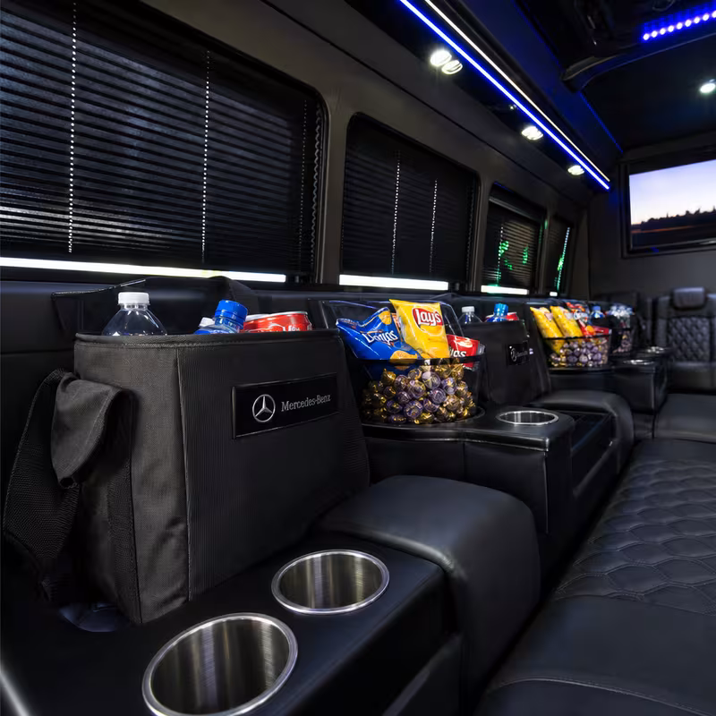 Party bus interior with wraparound leather seating and LED lighting in Fort Lauderdale